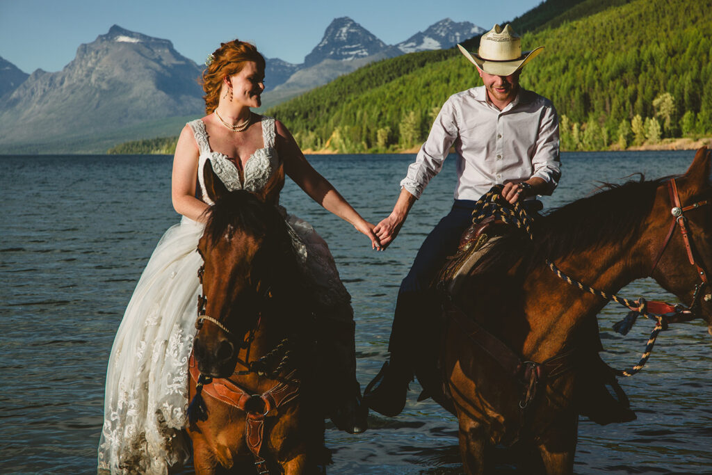 colorado elopement couple riding horseback through water