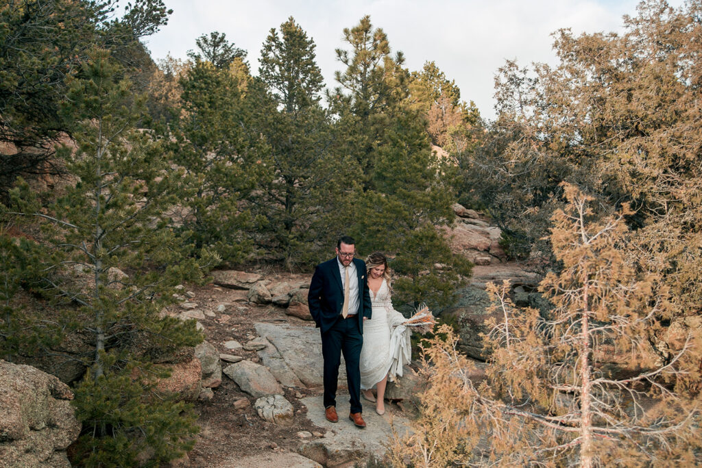 bride and groom hiking through buena vista