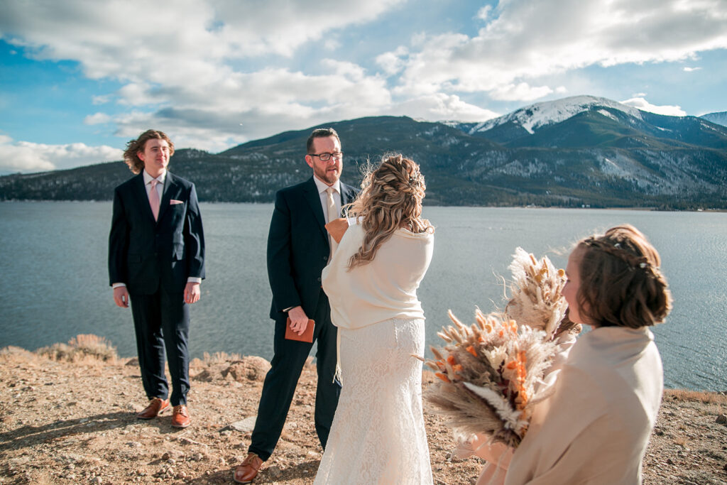 elopement ceremony with the elopement couple exchanging their vows and their kids are there to witness