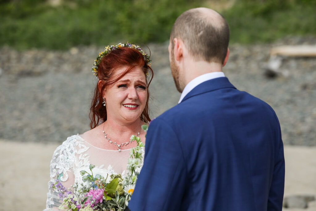 emotional bride and groom during their elopement ceremony at hug point, oregon coast