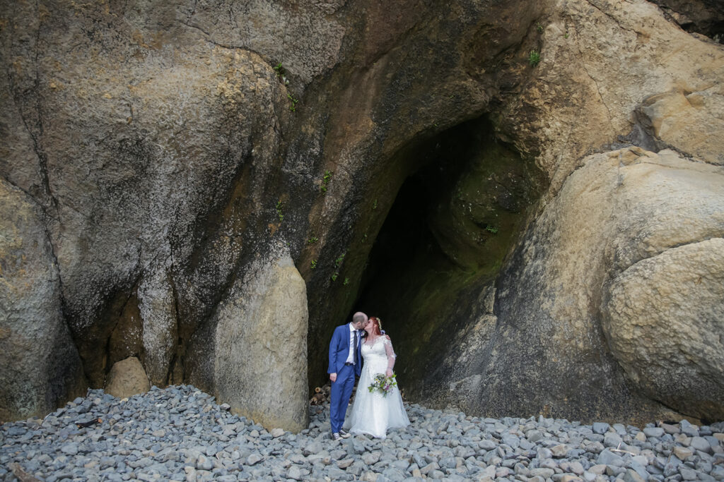 bride and groom inside a cave during their hug point elopement